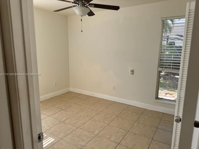 tiled empty room with plenty of natural light and ceiling fan