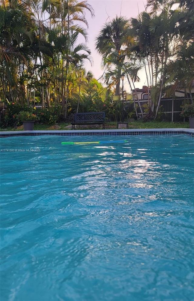 view of pool at dusk