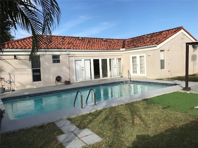 back of house with a patio, a yard, and french doors