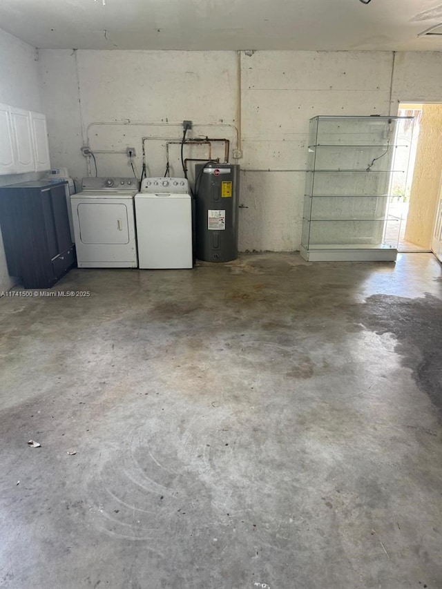 garage featuring independent washer and dryer and water heater