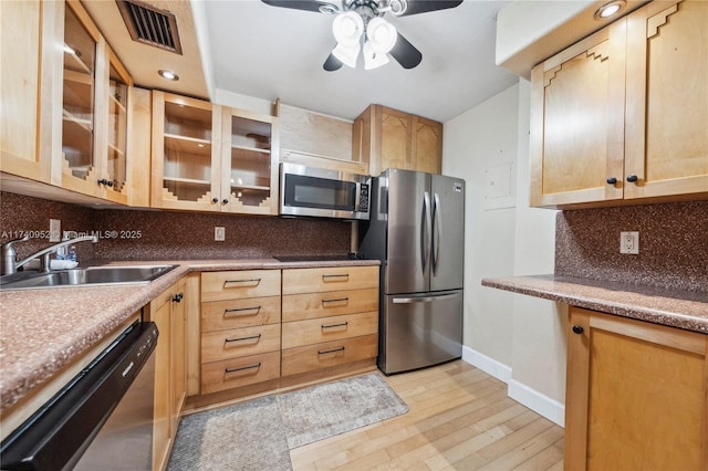 kitchen with backsplash, appliances with stainless steel finishes, sink, and light brown cabinets