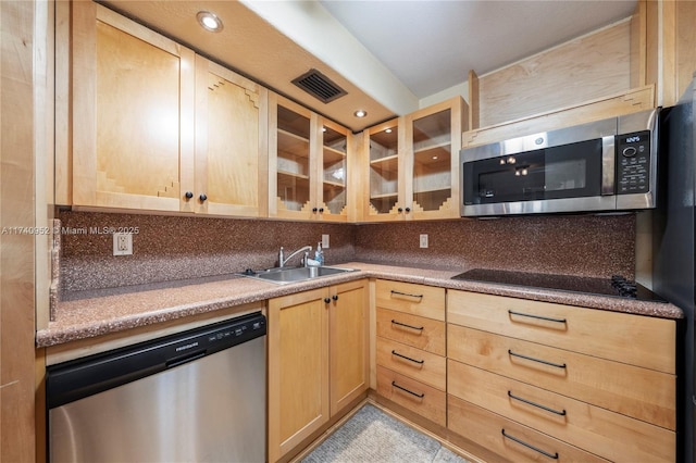 kitchen featuring light brown cabinetry, sink, decorative backsplash, and appliances with stainless steel finishes