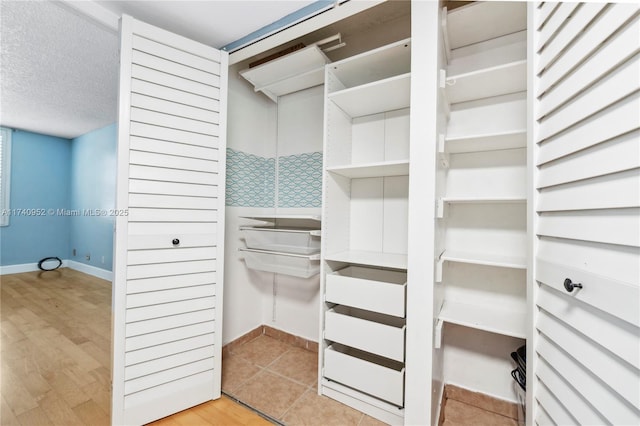 walk in closet featuring light wood-type flooring