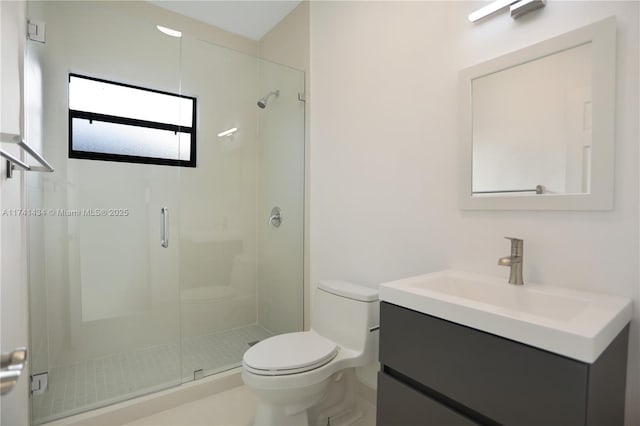 bathroom featuring vanity, toilet, and an enclosed shower