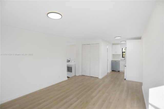 interior space with washer / clothes dryer and light hardwood / wood-style floors