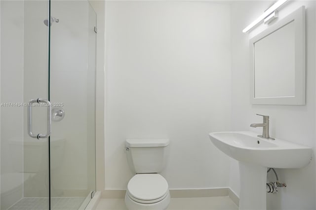 bathroom featuring sink, an enclosed shower, and toilet