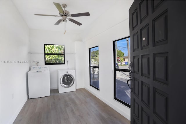 laundry room featuring ceiling fan, washer and clothes dryer, and light wood-type flooring