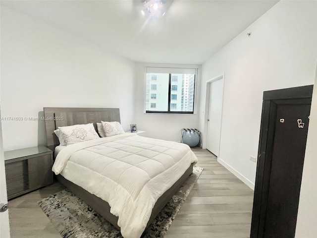 bedroom with hardwood / wood-style floors