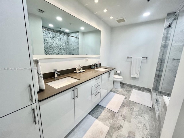 bathroom with vanity, an enclosed shower, and toilet