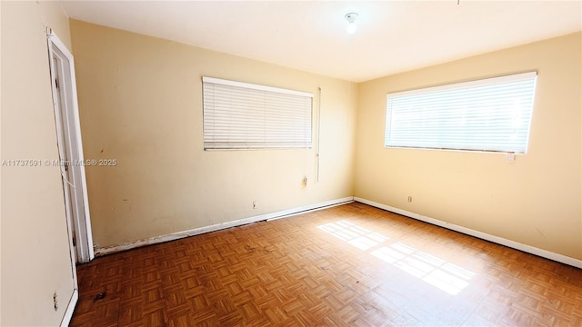 unfurnished room featuring dark parquet flooring