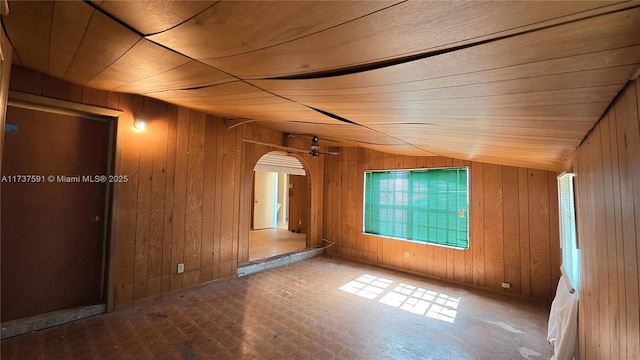 bonus room with lofted ceiling, wooden ceiling, and wooden walls