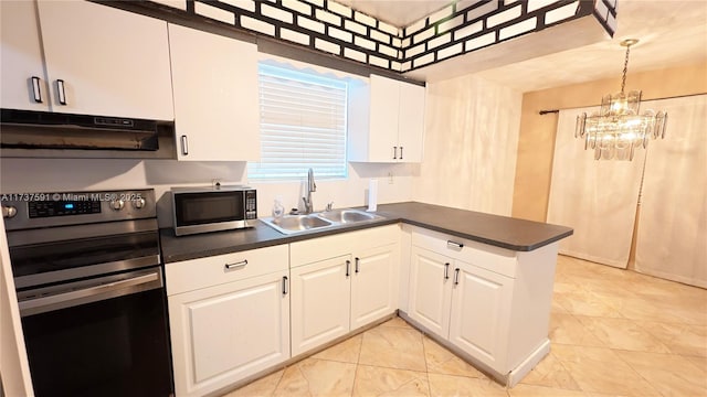 kitchen featuring appliances with stainless steel finishes, decorative light fixtures, white cabinetry, sink, and kitchen peninsula