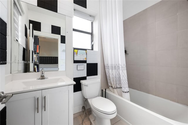 full bathroom with toilet, tile walls, vanity, shower / bath combination with curtain, and tile patterned flooring