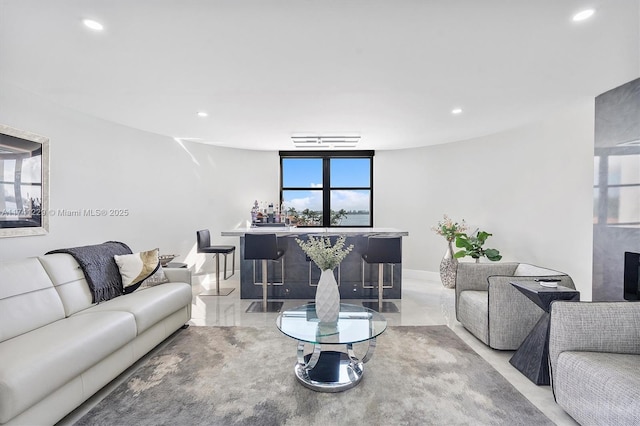living room featuring indoor bar and a wealth of natural light