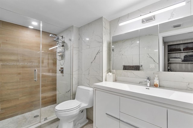 bathroom with a shower with shower door, tasteful backsplash, tile walls, vanity, and toilet