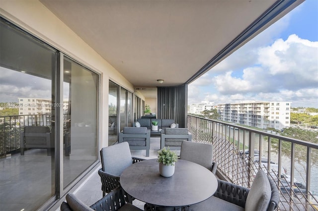 balcony with a water view and an outdoor living space