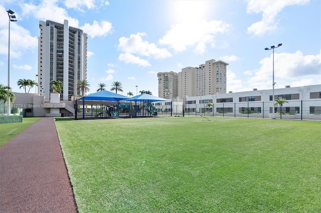 surrounding community with a lawn and a playground