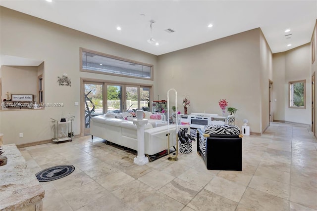 living room featuring a towering ceiling