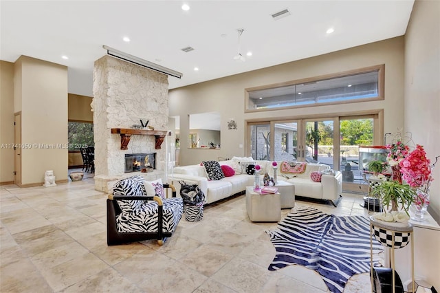 living room featuring a fireplace and a high ceiling