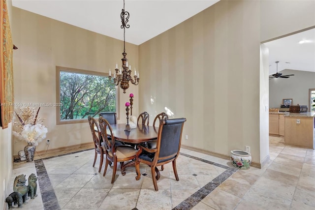 dining space featuring high vaulted ceiling and ceiling fan with notable chandelier