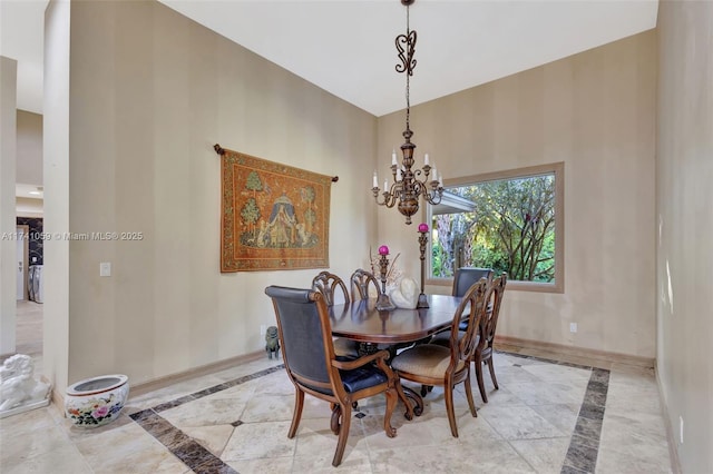 dining space featuring a chandelier and a towering ceiling