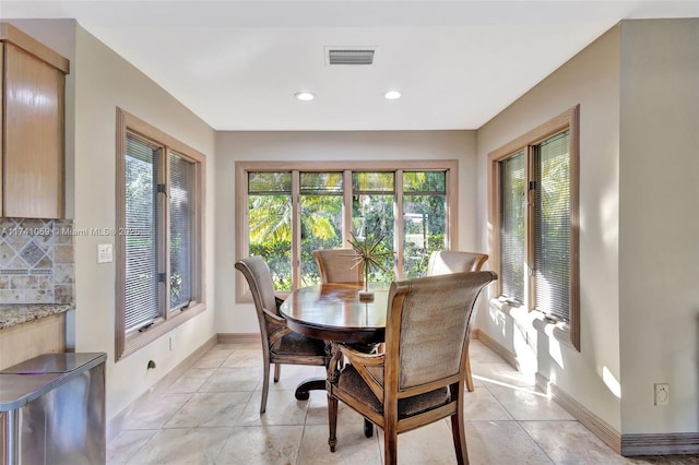 dining space featuring light tile patterned floors