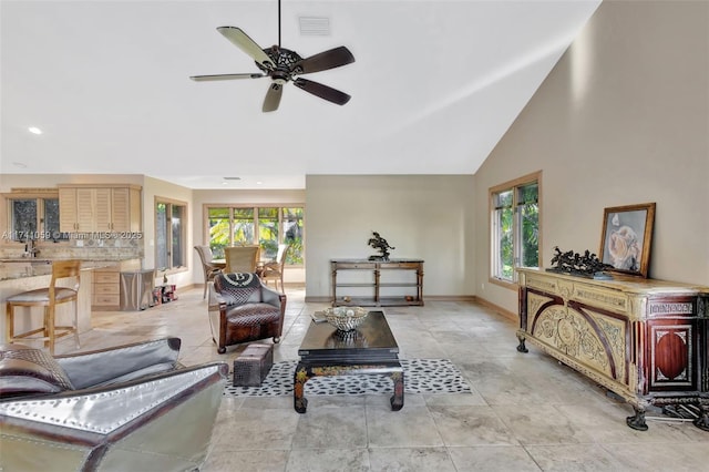 living room featuring high vaulted ceiling, ceiling fan, a wealth of natural light, and sink