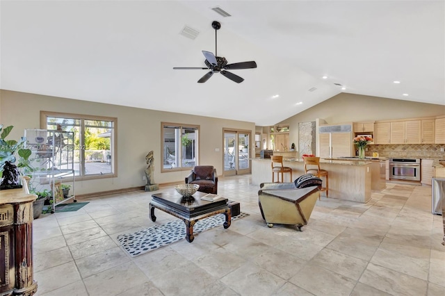 living room with high vaulted ceiling and ceiling fan