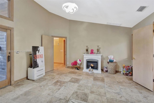 unfurnished living room with high vaulted ceiling