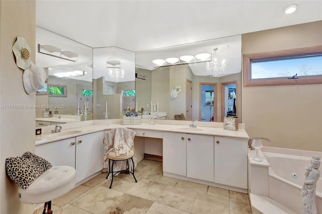 bathroom featuring a washtub and vanity