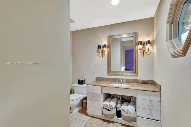 bathroom with vanity, toilet, and tile patterned floors