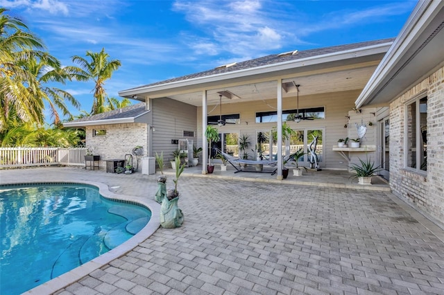 view of pool with ceiling fan and a patio area