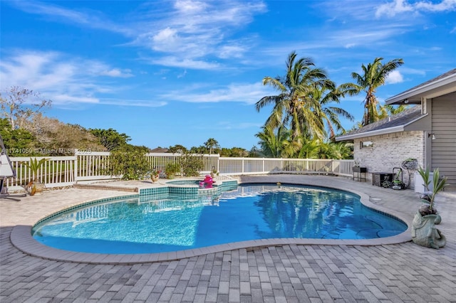 view of swimming pool featuring an in ground hot tub and a patio