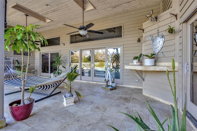 view of patio / terrace featuring ceiling fan and french doors