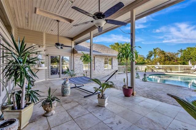 view of patio / terrace with a fenced in pool and ceiling fan