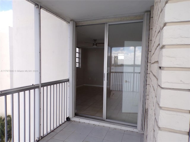 view of exterior entry with a balcony