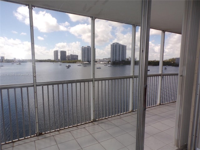 unfurnished sunroom with a water view