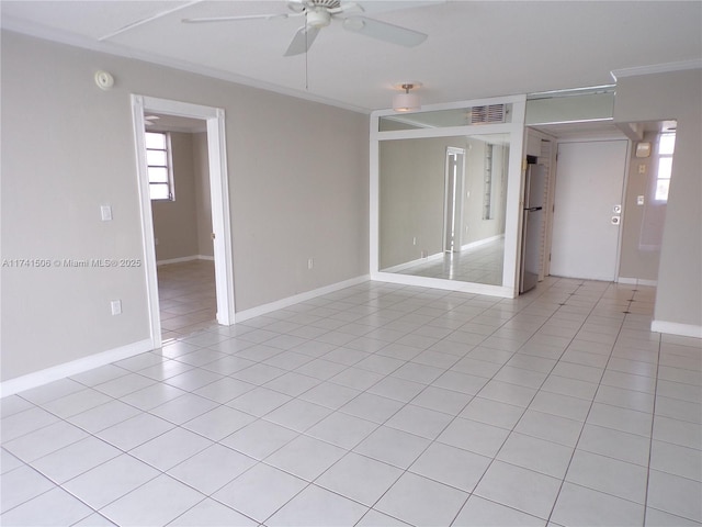 empty room with light tile patterned flooring, ornamental molding, and ceiling fan