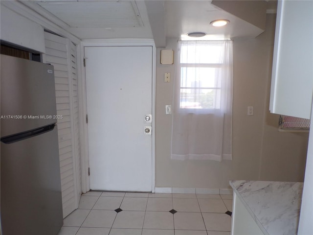 entryway with light tile patterned floors