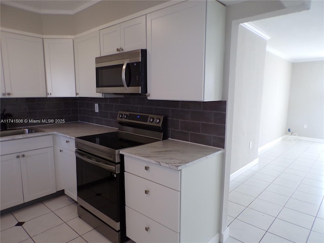 kitchen featuring white cabinetry, stainless steel appliances, and sink