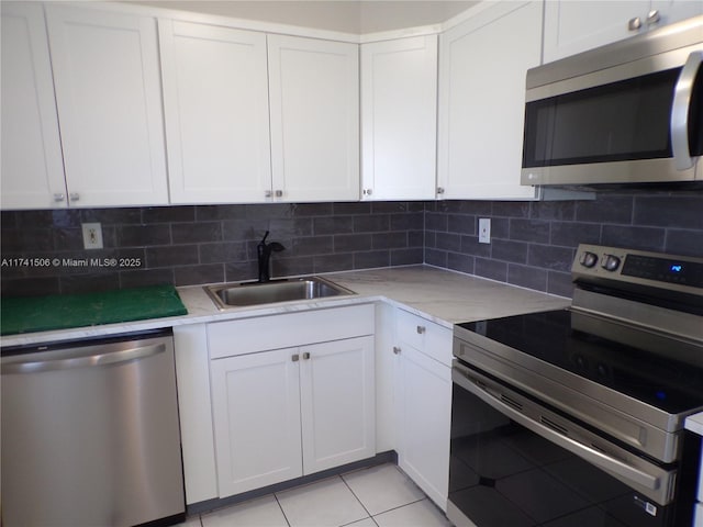 kitchen featuring white cabinetry, sink, and appliances with stainless steel finishes