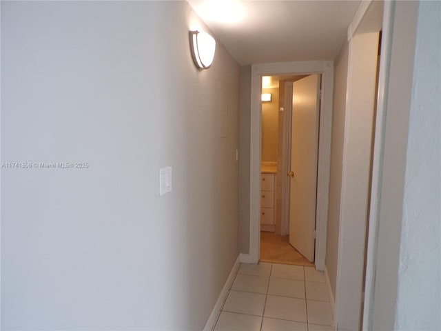 hall with light tile patterned floors