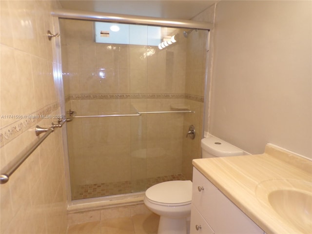 bathroom featuring vanity, toilet, and an enclosed shower