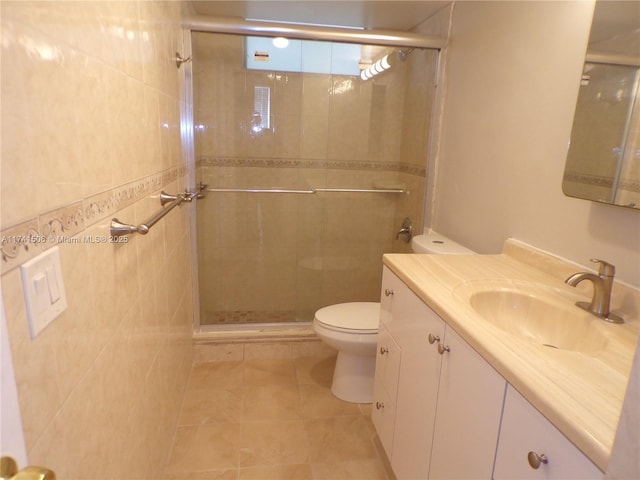 bathroom with vanity, toilet, a shower with shower door, and tile patterned flooring