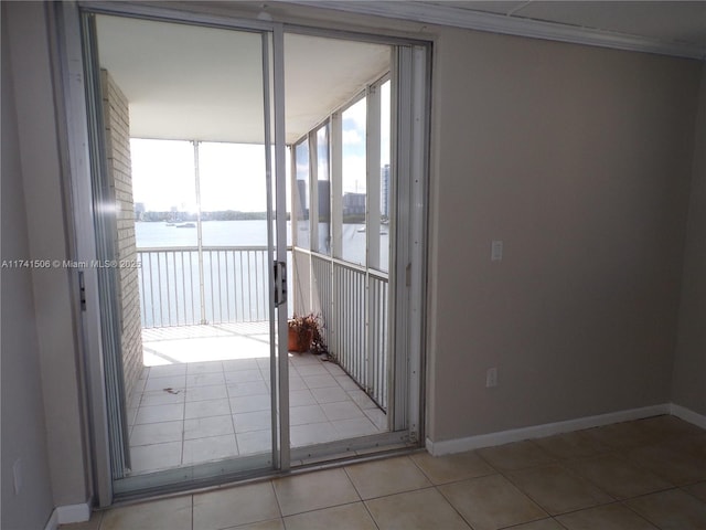 unfurnished room with light tile patterned flooring, a water view, and floor to ceiling windows