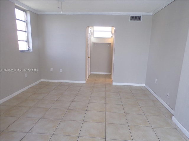 unfurnished room with light tile patterned floors and ornamental molding