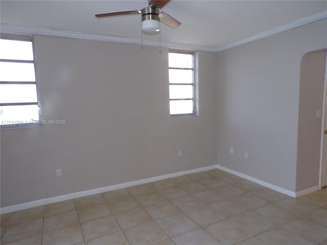 spare room with crown molding and ceiling fan