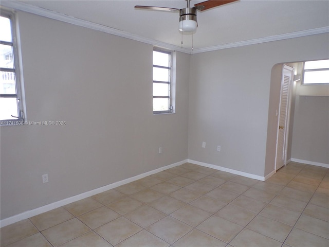 empty room featuring crown molding and ceiling fan