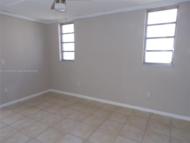 spare room with crown molding and light tile patterned floors