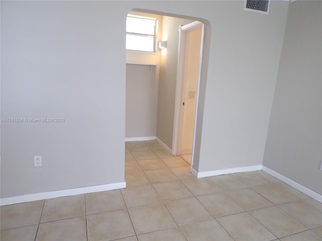 hall with light tile patterned floors